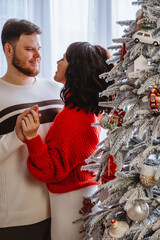 Wall Mural - lovely couple dancing in front of christmas tree