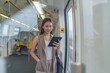 © StockPhotoRepublic - Asian Woman Using Digital Tablet While Commuting In A Skytrain