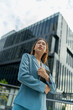 © StockPhotoRepublic - Young Businesswoman Using Digital Tablet In Front A Modern Office Building in a Financial District