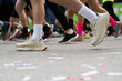 © JairoMZ - Closeup long exposure many persons and legs running marathon race stock photo with space for text non recognizable people on it