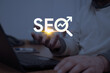 © Selman - Hand holding a glowing SEO icon with a rising arrow, symbolizing search engine optimization, digital marketing strategies, and website ranking improvements
