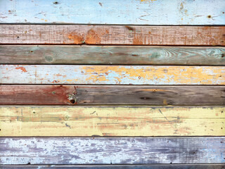 Wall Mural - A vibrant collection of weathered wooden planks showcasing a blend of blue, beige, and brown hues on a rustic backdrop