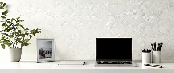 Poster - Minimalist modern home office desk with a laptop, and stationery on a white table against a wall with patterned wallpaper