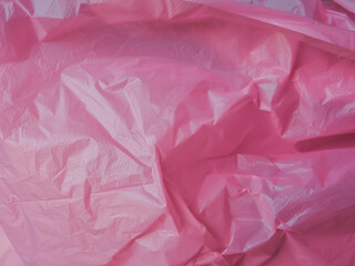 Wall Mural - pink wrinkled plastic texture for a pastel background.