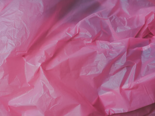 Wall Mural - pink wrinkled plastic texture for a pastel background.