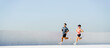 © muse studio - Couple Jogging Together on Sunny Day in Outdoor Setting, Enjoying Exercise and Fitness