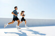 © muse studio - Couple Running Together on a Sunny Day, Enjoying Outdoor Fitness and Healthy Lifestyle