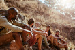 © Marko Geber - Group of hikers taking a break on a mountain trail
