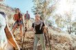 © Marko Geber - Group of friends hiking on a steep trail in the forest