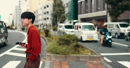 Typing, walking and Japanese man with smartphone, travel and online chatting in city. Outdoor, person and student with cellphone, social media and message to contact, texting and network with app