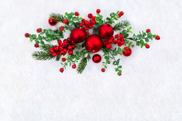 Wall Mural - christmas decoration. red christmas balls, red berries, branches christmas tree on snow with space f