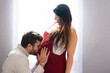 © Arianne - Pregnant woman with her husband giving him a kiss on the belly