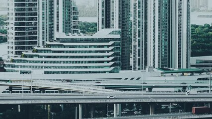 Wall Mural - Aerial view of city buildings and busy traffic overpass