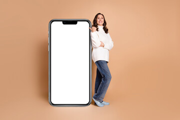 Photo of charming lovely woman wear trendy clothes presenting menu empty space isolated on beige color background