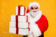 © deagreez - Portrait of funny funky grey hair santa claus in red hat hold packages he brings for good kids people celebrate newyear holly christmas time isolated over yellow color background