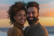 © Markus Schröder - Portrait of a happy mixed race couple in their 30s wearing a classic turtleneck sweater isolated on vibrant beach sunset background