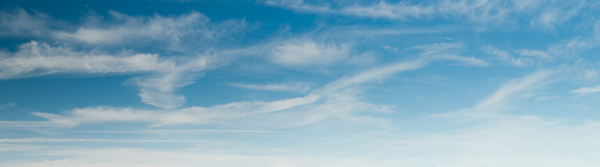 Wall Mural - Soft white clouds in the blue sky. Panoramic sky background 