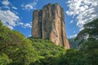 © Alla - A massive rock formation dominates the scenery amidst lush vegetation