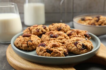 Delicious oatmeal cookies with raisins and nuts on table, closeup