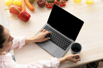 Aufkleber - Breakfast Concept. Above top high angle view of young female using personal computer with black empty screen for mock up design, checking email or browsing internet sitting at table drinking coffee