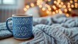 © AGUNG - Cozy winter scene with tea mug and knit blanket.