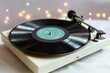© Alla - A vinyl record player sits atop a white table, ready for use