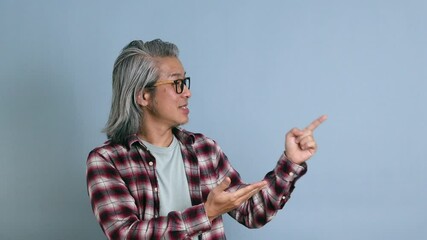 Wall Mural - The Asian man standing on the blue background.