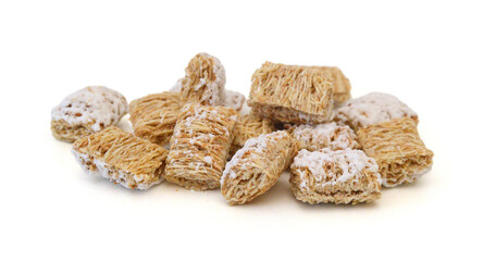 Breakfast setting with frosted wheat cereal on white background