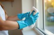 © Kateryna - Close up woman hands in blue gloves with white cleaning cloth, washing window . white interior on background with book shelves. soft morning sunlight, sun rays, shadows