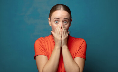 Wall Mural - looking happy, cheerful, lucky and surprised covering mouth with both hands