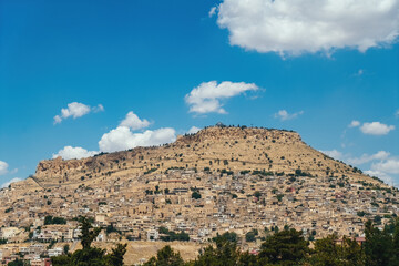 Wall Mural - Mardin old city from a distance. Old Mardin historical buildings, streets. Mardin city view in Turkey.