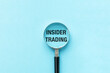 © Pawel - Magnifier with the text Insider Trading on blue background. Business concept.