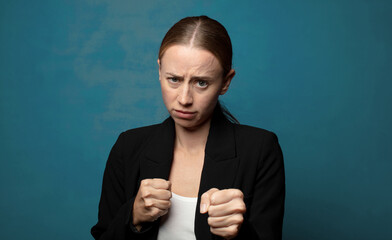 Wall Mural - looking confident, angry, strong and aggressive, with fists ready to fight in boxing position