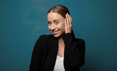 Wall Mural - smiling cheerfully and casually, taking hand to head with a positive, happy and confident look