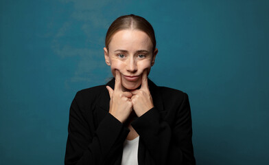Wall Mural - smiling confidently pointing to own fake smile