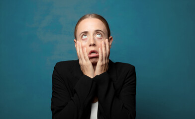 Wall Mural - feeling shocked and scared, looking bored with hands on cheeks