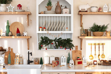 Wall Mural - Light open Xmas kitchen in scandi style. Interior design wooden Cuisine furniture with countertop, sink with faucet and and stove with oven. Kitchen shelves with with Christmas decoration and utensils