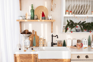 Wall Mural - Stylish Light Scandi kitchen with Sink with black faucet. Wooden shelves with with Christmas decoration and utensils on Cuisine. Countertop with cookware. Interior design open organization on kitchen.