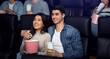 © Prostock-studio - On movie date. Happy smiling boyfriend and girlfriend in cinema