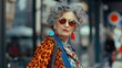 © Liliya Trott - Old fashionable woman, street photo. Lady with grey hair wearing sunglasses and colorful orange jacket with pattern, travelling, outdoors
