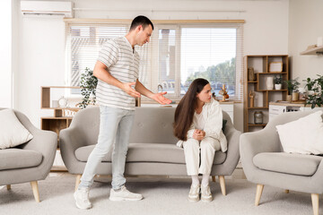 Wall Mural - Young man with his offended wife at home