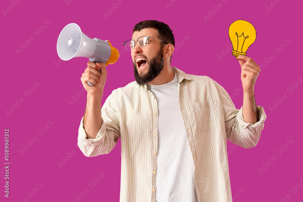Handsome young man with paper light bulb and megaphone screaming on purple background