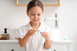 © Pixel-Shot - Cute little girl with contact lenses in bathroom