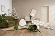 © Pixel-Shot - Interior of messy living room with overturned table, shelf units and plants after earthquake