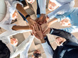 © Prostock-studio - Business Unity And Teambuilding. United Colleagues Standing In Circle Holding Hands Together In Modern Office. Bottom View