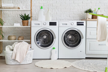 Wall Mural - Interior of laundry room with washing machines, basket and shelf unit