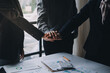 © ARMMY PICCA - Handshake in agreement against young business people in board room meeting