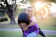 © chaunpis - Cute children play in the park at sunset.