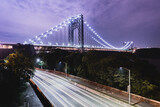  A long exposure over I-95 with traffic below during rush hour, and the George Washington bridge in the background, with purple clouds at night.