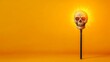 © Ndoomyim - Illuminated skull lamp on vibrant yellow backdrop, a captivating contrast of light and shadow